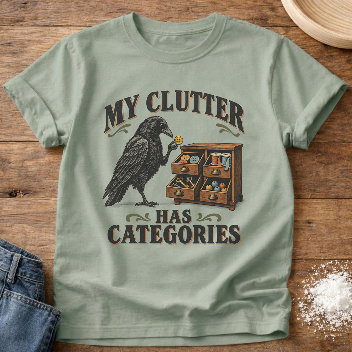 Knead More Fun Clutter Categories Crow graphic t-shirt in Bay