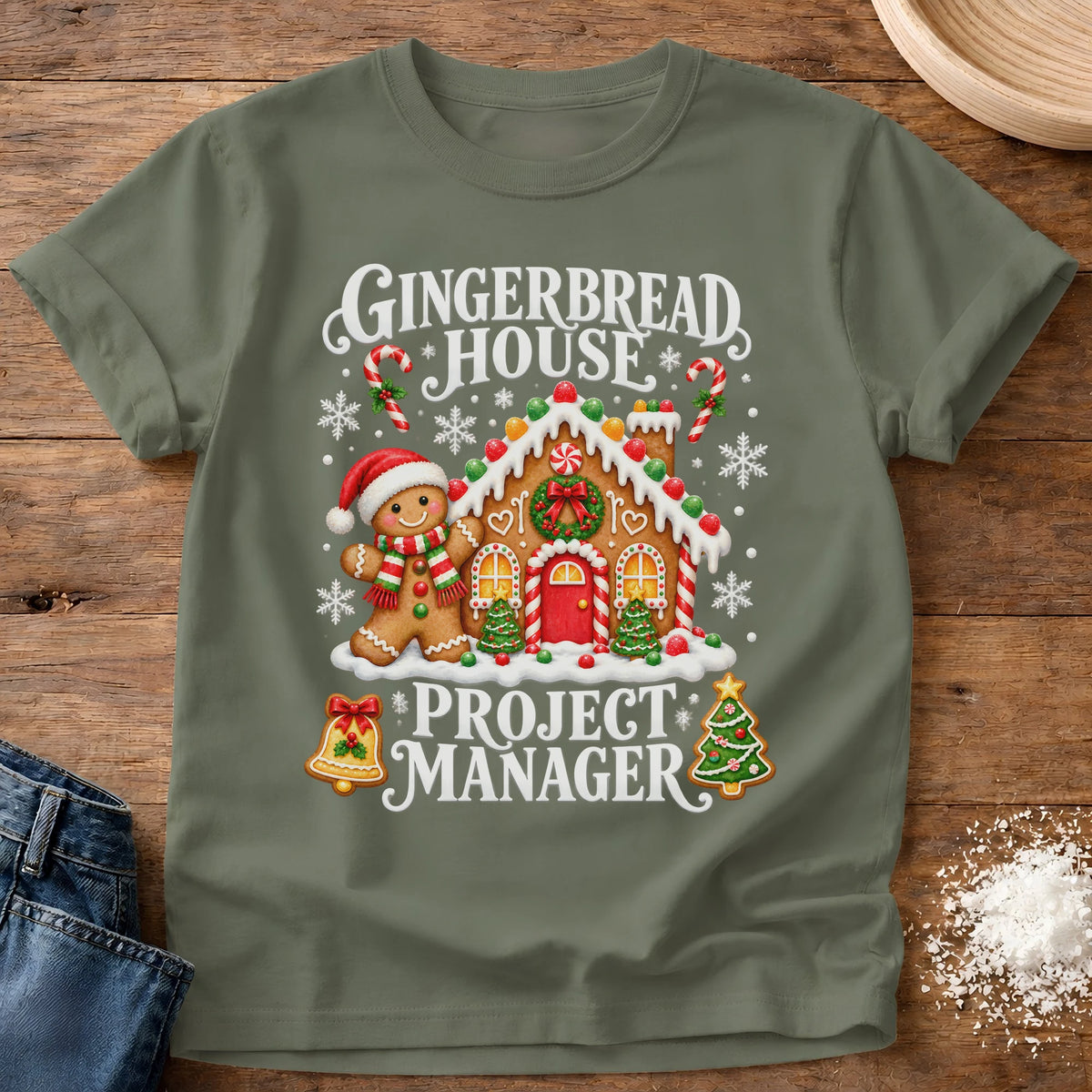 Knead More Fun Gingerbread Manager gingerbread house t-shirt in Moss