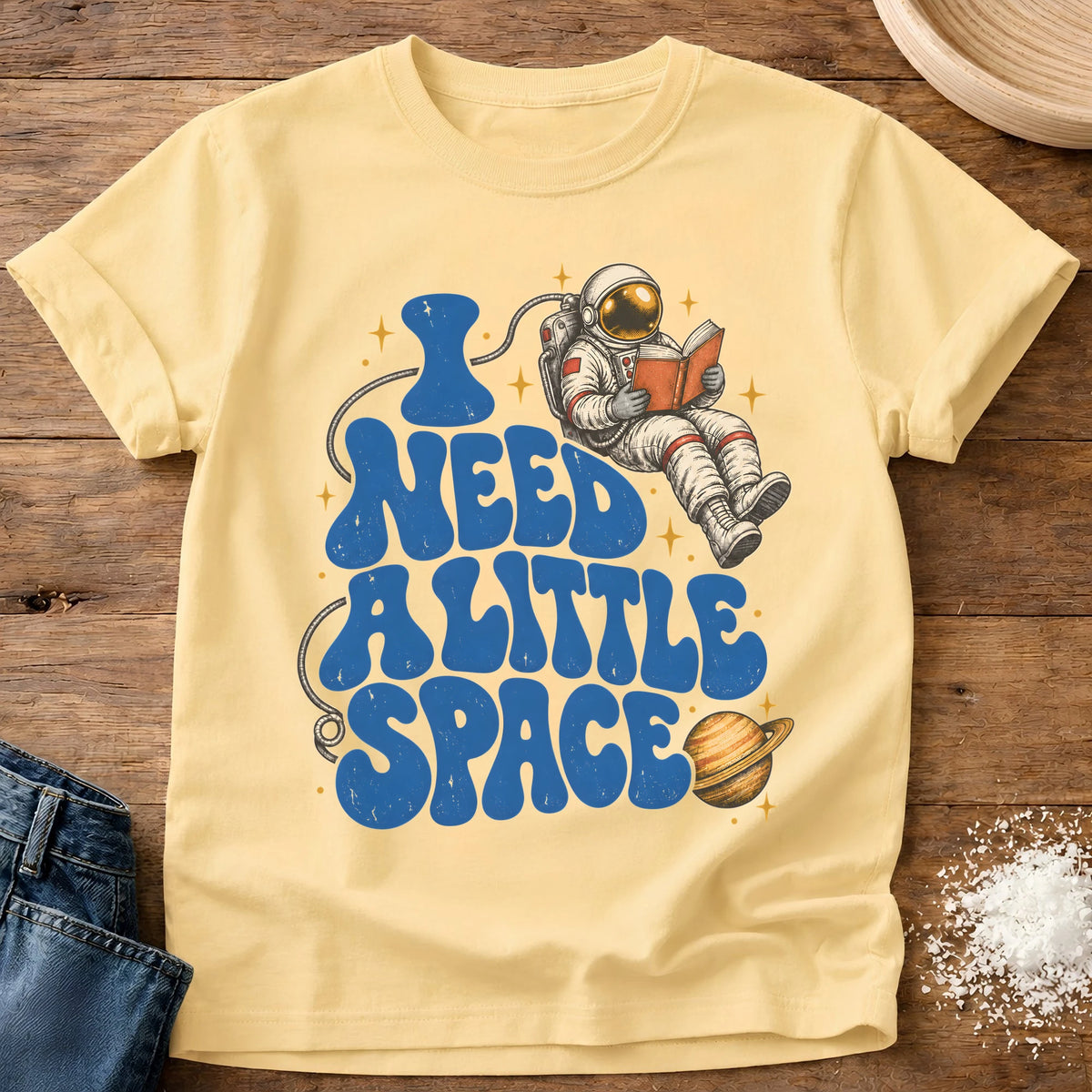 Knead More Fun Need Little Space astronaut reading t-shirt in Butter